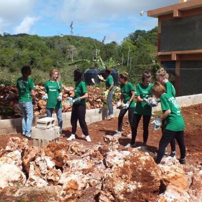 A group of Projects Abroad volunteers building a playground in Jamaica. An area being cleared for construction as part of building volunteer work in Jamaica with a group.